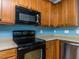 Close-up of the kitchen showcasing modern appliances and wooden cabinetry at 205 Cedar Elm Rd, Durham, NC 27713
