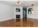 Bright living room featuring a fireplace with mounted TV and gleaming hardwood floors at 205 Cedar Elm Rd, Durham, NC 27713