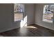 Bright bedroom featuring hardwood floors and two windows offering natural light at 209 King St, Oxford, NC 27565