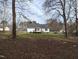 Spacious backyard with a deck and mature trees at 212 Davis Farm Dr, Selma, NC 27576