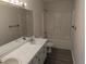 Well-lit bathroom featuring double vanity, and a shower-tub combo at 212 Davis Farm Dr, Selma, NC 27576