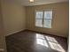 Bedroom featuring a large window and wood-look floors at 212 Davis Farm Dr, Selma, NC 27576