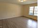 Clean bedroom space featuring wood-look flooring and natural light at 212 Davis Farm Dr, Selma, NC 27576