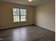 Bedroom with wood-look floors and natural light from the window at 212 Davis Farm Dr, Selma, NC 27576