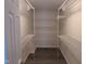 Walk-in closet boasts wire shelving and a wood-look floor at 212 Davis Farm Dr, Selma, NC 27576