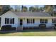 Charming single-story home featuring a covered front porch and well-maintained landscaping at 212 Davis Farm Dr, Selma, NC 27576