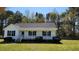Inviting exterior of a single-story home with a classic front porch and green lawn at 212 Davis Farm Dr, Selma, NC 27576