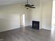 Spacious living room featuring a fireplace and ceiling fan for a comfortable atmosphere at 212 Davis Farm Dr, Selma, NC 27576