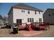 View of the back of the house, deck, and patio with brick pavers at 212 Liberty Rose Dr, Morrisville, NC 27560