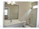 Bright bathroom features a vanity with sink, large mirror, and shower-tub combination at 212 Liberty Rose Dr, Morrisville, NC 27560