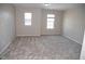 Bright bedroom features neutral carpet, fresh paint, and natural light from two windows at 212 Liberty Rose Dr, Morrisville, NC 27560