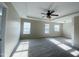 Large bedroom with neutral carpet, natural light, and tray ceiling at 212 Liberty Rose Dr, Morrisville, NC 27560