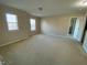 Large, carpeted bedroom with abundant natural light, creating a warm and inviting atmosphere at 212 Liberty Rose Dr, Morrisville, NC 27560