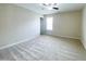Neutral bedroom features carpet, ceiling fan, and natural light through the window at 212 Liberty Rose Dr, Morrisville, NC 27560