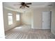 Spacious bedroom with neutral carpet, ceiling fan, and natural light at 212 Liberty Rose Dr, Morrisville, NC 27560