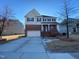 Traditional two-story house featuring a two-car garage and brick accents at 212 Liberty Rose Dr, Morrisville, NC 27560
