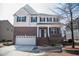 Inviting two-story home with brick facade, manicured landscaping, and a two-car garage at 212 Liberty Rose Dr, Morrisville, NC 27560
