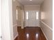 Bright foyer featuring hardwood floors, neutral walls, and classic white trim at 212 Liberty Rose Dr, Morrisville, NC 27560