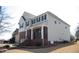 View of the two story home showcasing brick facade and a covered front porch at 212 Liberty Rose Dr, Morrisville, NC 27560