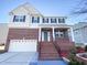 Charming two-story brick home with well-manicured landscaping and an inviting front porch at 212 Liberty Rose Dr, Morrisville, NC 27560