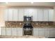 Modern kitchen with granite countertops, tile backsplash, stainless steel appliances, and ample cabinetry at 212 Liberty Rose Dr, Morrisville, NC 27560