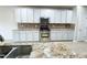 Well-lit kitchen features stainless steel appliances, granite countertops, and white cabinets at 212 Liberty Rose Dr, Morrisville, NC 27560