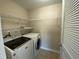 Well-organized laundry room complete with modern washer and dryer, and shelving at 212 Liberty Rose Dr, Morrisville, NC 27560