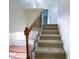 Carpeted staircase with metal spindles and wooden banister at 212 Liberty Rose Dr, Morrisville, NC 27560