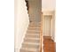 Carpeted staircase with wooden banister leading to the upper level at 212 Liberty Rose Dr, Morrisville, NC 27560