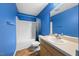 Bright blue bathroom with shower-tub combination and wooden vanity at 220 Courtland Dr, Angier, NC 27501