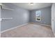 Neutral bedroom with carpet, window, and white door at 220 Courtland Dr, Angier, NC 27501