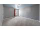 Spacious bedroom with neutral gray walls, plush carpeting, and natural light at 220 Courtland Dr, Angier, NC 27501