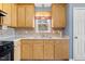 Kitchen featuring wood cabinets, a window, and laminate countertops at 220 Courtland Dr, Angier, NC 27501