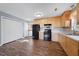 A well lit kitchen with wooden cabinets, light countertops and a black oven at 220 Courtland Dr, Angier, NC 27501