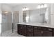 This bathroom has a glass shower and double sink vanity with drawers and cabinets for storage at 223 Frosted Iris Lane Ln # 176, Garner, NC 27529