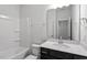 This bathroom has a shower-tub, a white vanity top, and dark cabinets at 223 Frosted Iris Lane Ln # 176, Garner, NC 27529