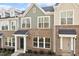 Charming exterior view of newly built townhomes, showcasing a mix of brick and siding finishes and inviting front entrances at 223 Frosted Iris Lane Ln # 176, Garner, NC 27529