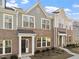 Attractive exterior of a townhome displaying brick facade, large windows, and a covered entryway at 223 Frosted Iris Lane Ln # 176, Garner, NC 27529
