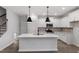 New kitchen with island, pendant lighting, stainless steel appliances, and quartz countertops at 223 Frosted Iris Lane Ln # 176, Garner, NC 27529