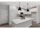 Kitchen island with quartz countertop, white cabinets, and stainless steel sink at 223 Frosted Iris Lane Ln # 176, Garner, NC 27529