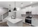 Modern kitchen featuring a center island, stainless steel appliances, and stylish pendant lighting at 223 Frosted Iris Lane Ln # 176, Garner, NC 27529