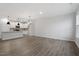Open floor plan with wood-look flooring leading to kitchen with white cabinets at 223 Frosted Iris Lane Ln # 176, Garner, NC 27529