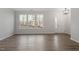 Inviting living room featuring an entry door, three windows and modern lighting at 223 Frosted Iris Lane Ln # 176, Garner, NC 27529