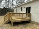 Wide shot of the wooden deck attached to the single story home with vinyl siding at 2242 Eldridge Rd, Newton Grove, NC 28366
