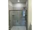 Contemporary bathroom featuring a shower with a glass enclosure and light gray wall tiles at 2242 Eldridge Rd, Newton Grove, NC 28366