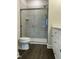 Modern bathroom featuring a glass-enclosed shower with gray tiling and sleek fixtures at 2242 Eldridge Rd, Newton Grove, NC 28366