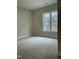 Carpeted bedroom with a large window providing plenty of natural light at 2242 Eldridge Rd, Newton Grove, NC 28366