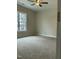 Bedroom with a ceiling fan, a large window for natural light, and plush carpeting at 2242 Eldridge Rd, Newton Grove, NC 28366