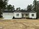 Charming single-story home featuring a two-car garage and a welcoming covered porch at 2242 Eldridge Rd, Newton Grove, NC 28366