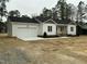 Beautiful exterior view of a single-story home with a spacious two-car garage and covered porch at 2242 Eldridge Rd, Newton Grove, NC 28366